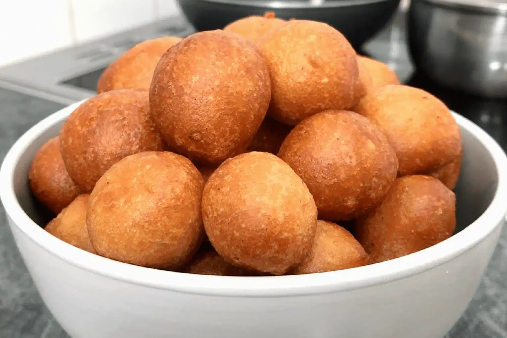 Golden fried puff puff balls on a plate