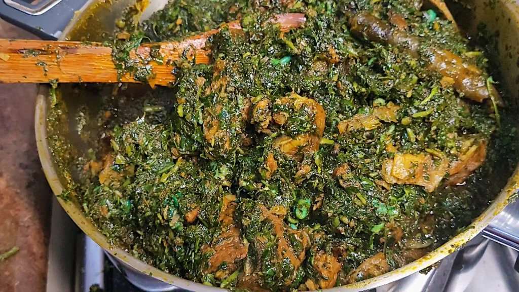 afang soup simmering with meat and periwinkle