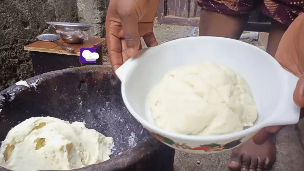 pounded yam pound in a wooden mortar and pestle