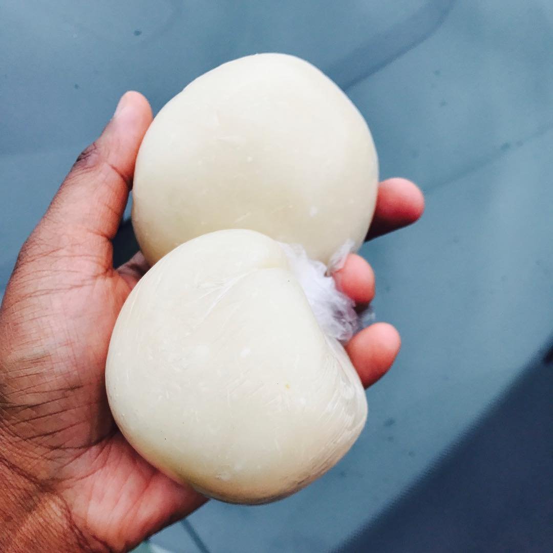 hand rolling fufu into a ball