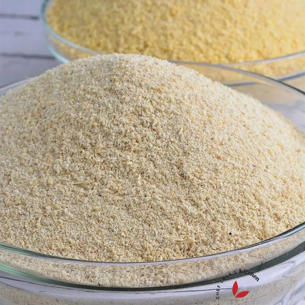 White and yellow garri flakes side by side in bowls