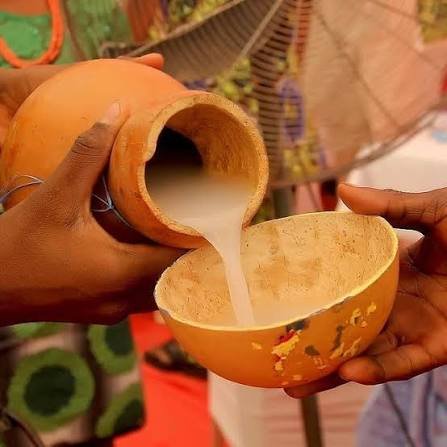 cloudy white palm wine being poured
