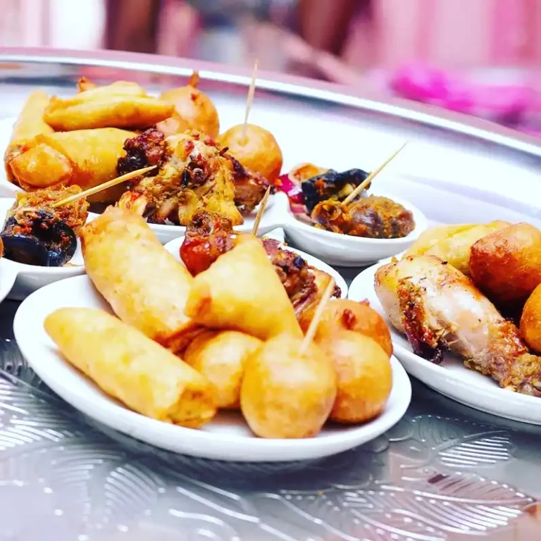 small chops platter with puff puff and spring rolls