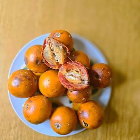 whole agbalumo fruits in a bow